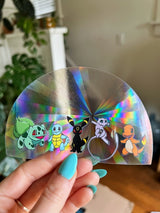 Pokemon Inspired (featuring Umbreon, Mew, Charmander, Squirrel, & Bulbasaur) rainbow prismatic window decal.