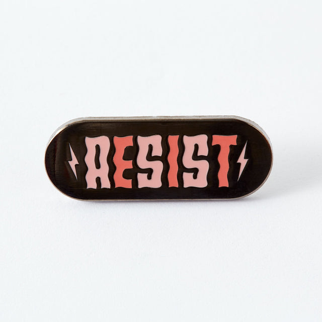 If they think we’re going to take their shit lying down, they can think again. Now is the time to resist. To fight back. To protest. To tell politicians and power trippers where to put their vitriol. And when we are lying down (because we all need a break) we’ll be wearing this pin.